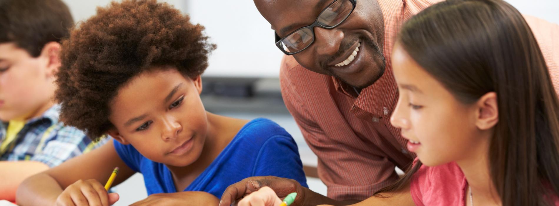 Teacher helping students